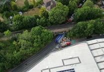 HGV overturns after striking Wrecclesham bridge – crushing a car