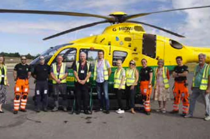 Lindford fete organising committee members meet Hampshire and Isle of Wight Air Ambulance staff at Thruxton airfield, September 2022.