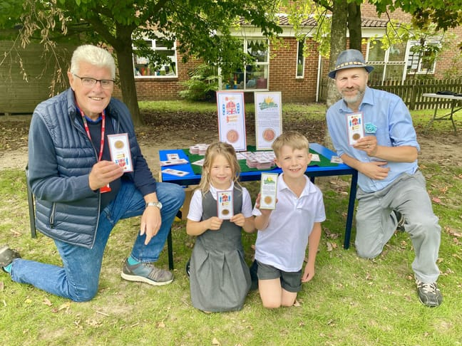 Phil Bates (left), pupils Lola and Rory and headteacher Richard Austin
