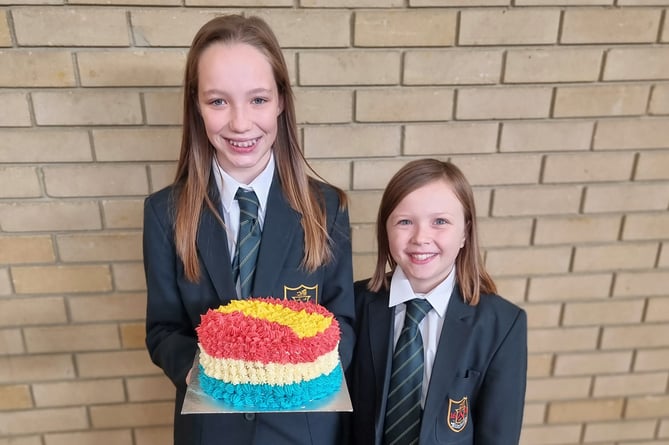 Year 7 pupils Pippa and Raphy with their Spanish-themed cake, Eggar’s School, Alton, Ukraine bake-off, October 2022.