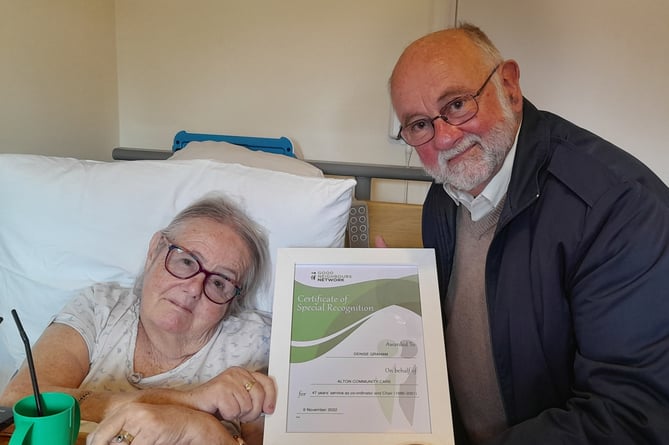 Denise Graham receives a Certificate of Special Recognition from Alton Community Care chairman Bill Griffin, November 2022.
