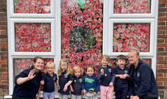 Kingsley nursery children make giant poppy with their painted hands