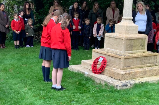 St Mary’s Bentworth CE Primary School head pupils Joy and Remi lay a wreath at the War Memorial in St Mary’s Church churchyard, Bentworth, November 11th 2022.