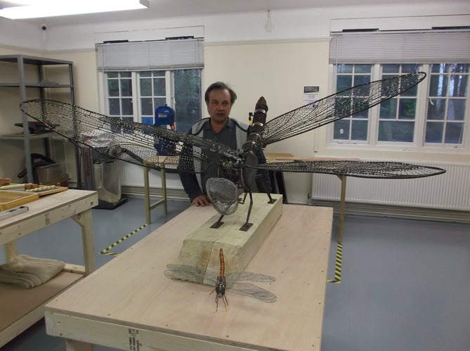 Cllr Roger Russell with a wire sculpture dragonfly he made, SiGNAL Bordon, April 4th 2019.