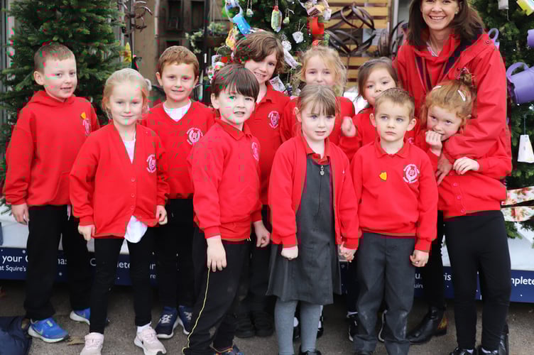 Children from Badshot Lea Village Infant School in front of their winning tree with headteacher Gemma Ball