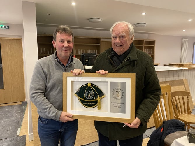 Fernhurst Cricket Club chairman Jon Meier presents John Mitchell with his framed honours cap