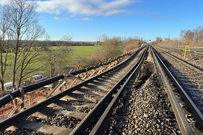 The landslip, on an embankment to the northeast of Hook station, has left only two tracks of the four-track railway passable by trains