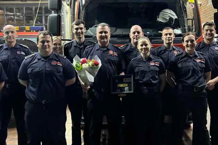 Paul Guy, with flowers, retires from Bordon fire station, February 6th 2023.