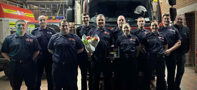 Paul Guy, with flowers, retires from Bordon fire station, February 6th 2023.