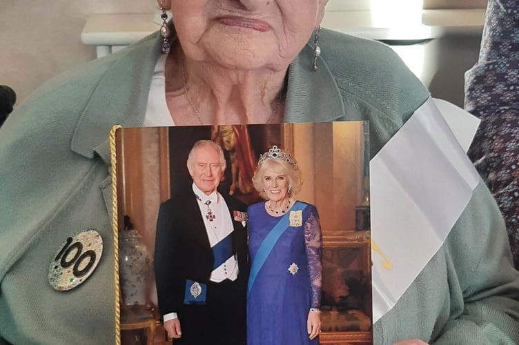 100-year-old Doris Beryl Pharo with her card from the King and Queen Consort