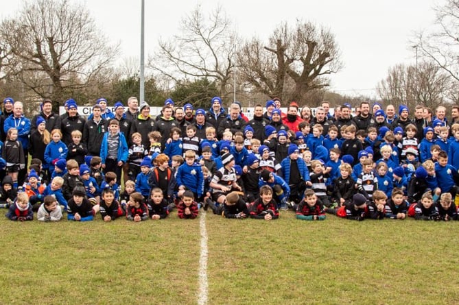 The 2023 Farnham Rugby Club Mini Tour players and coaches line up with some of the opposition from Chard