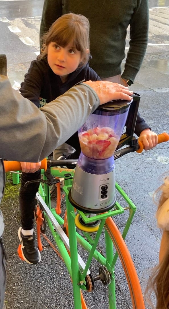 Clara Page rides the smoothie bike at Haslemere's Great Green Get Together