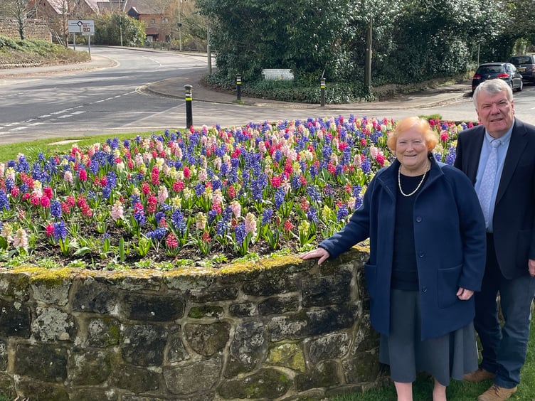 Councillors Angela Glass and Bill Mouland next to Liphook’s new red, white and blue coronation flower bed