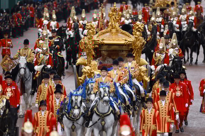 Their Majesties The King and Queen Consort departed Westminster Abbey in the Gold State Coach, flanked by eighteen representatives of the Realms.

The 1.42 miles-long Coronation Procession was formed of eight groups from the Household Division, Royal Navy, British Army, Royal Air Force and Commonwealth, together with 19 bands. Led by the Household Cavalry Mounted Band and The Kingâs Troop Royal Horse Artillery, the route was the reverse of the initial Procession to the Abbey, taking in Parliament Square, Whitehall, Trafalgar Square, Admiralty Arch, and The Mall. 

More than 5,000 personnel took part, including 4,000 people in the procession itself, 1,000 street-liners, 200 members of the Guard of Honour and 200 people carrying the Standards, Colours, Guidons and Truncheon.  

The Procession Group bands played up to eight marches, depending on their position in the Procession, before reducing to a drumbeat as they processed into position in the Buckingham Palace Garden for the Royal Salute. 
