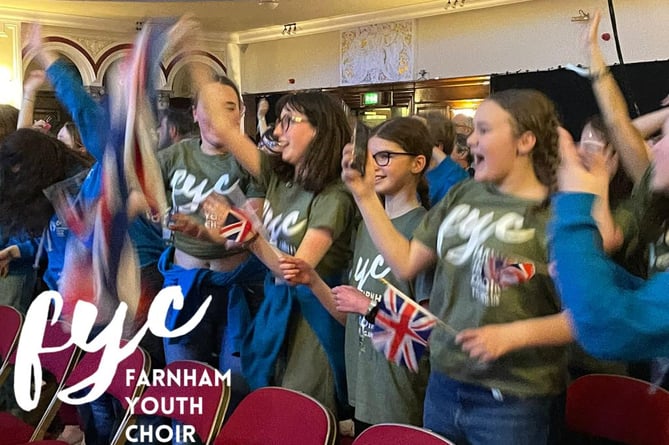 Farnham Youth Choir singers celebrating winning a gold trophy in Hull