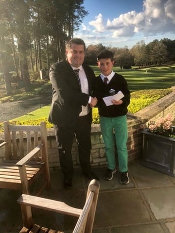 Ollie McDonald receives the Liphook Junior Open prize from Grant Masterton