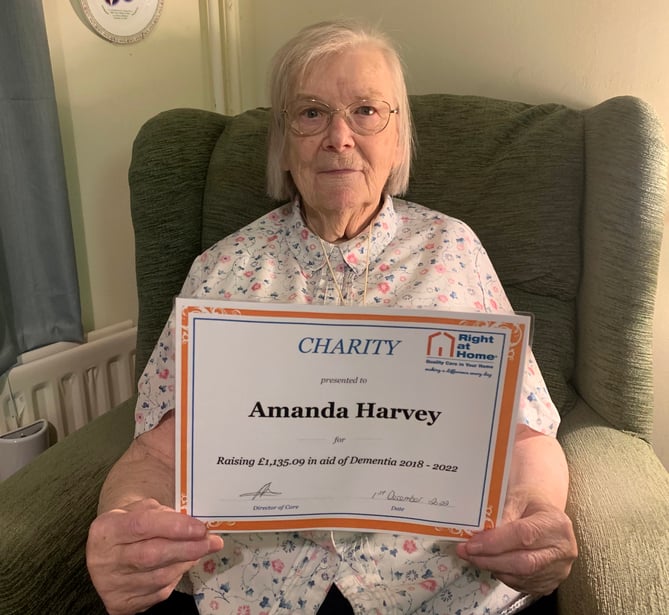 Pensioner Amanda Harvey with her Right at Home GF certificate of appreciation
