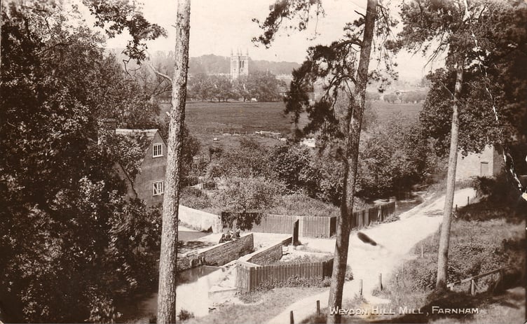 The picturesque former Weydon Hill Mill, overlooking Farnham's flood meadows and St Andrew's Church in the distance