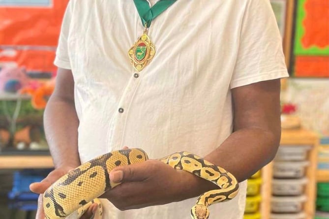 Whitehill town mayor Cllr Leeroy Scott meets a snake at the St Matthew’s CE Primary School summer fair in Blackmoor on June 24th 2023.