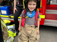 Bordon firefighters recruit seven-year-old Freddie at school fair