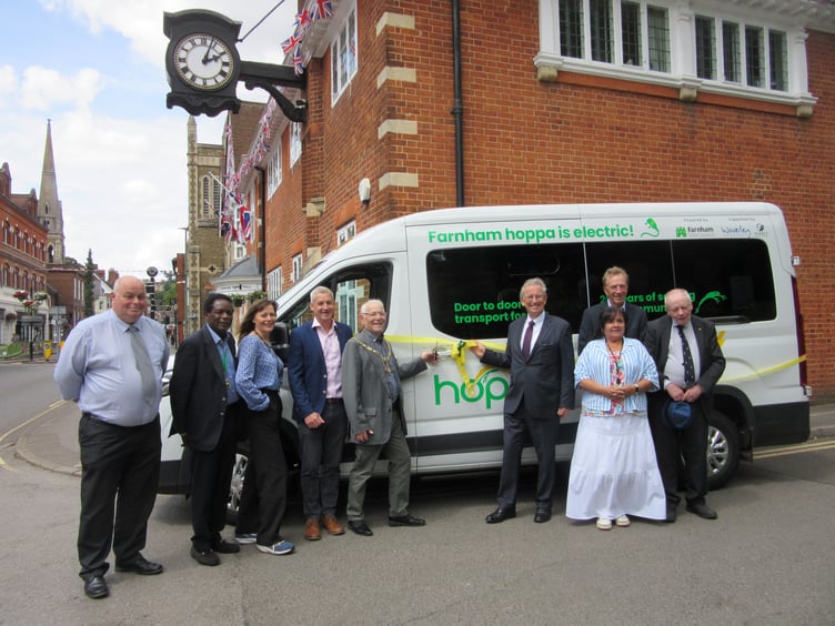 Representatives from Farnham Town Council and hoppa celebrate the launch of a new electric bus which will service the Farnham area