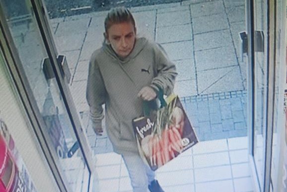 Woman entering Superdrug, High Street, Alton, August 10th 2023.