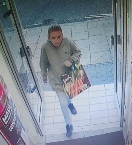 Woman entering Superdrug, High Street, Alton, August 10th 2023.