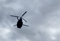 Watch the incredible moment a Chinook flies just metres over golfers