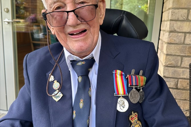 John Loader, 99, with his pin and medal