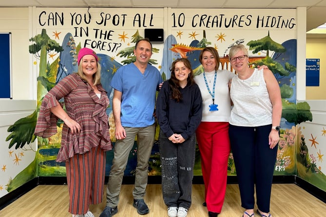 Unveiling of mural in children's waiting room at The Wilson Practice, Alton, October 2023. From left: Ríana Gallagher, Dr Oliver Kemp, Flossy Waters, Rachael Sowerby and reception manager Sharon Stevens
