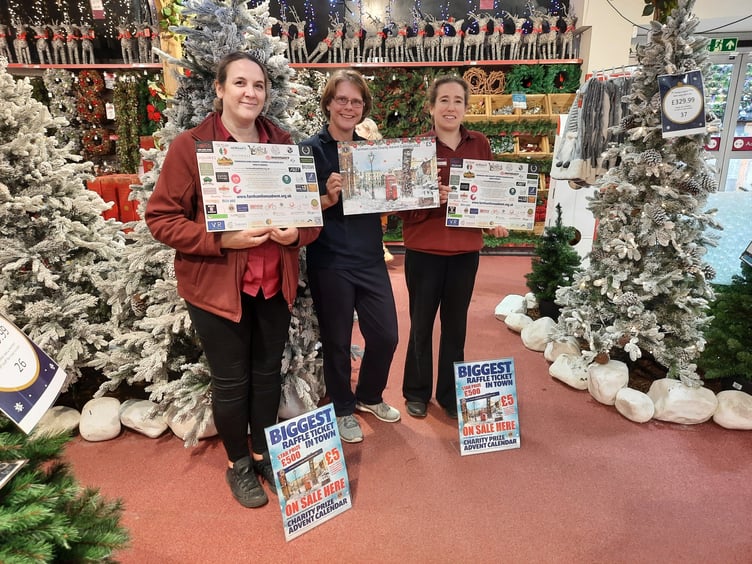 Farnham Lion Deborah Nugent with Squires staff members Debbie Hook and Lizzie Winton at the launch of Farnham Lions' Charity Advent Calendar