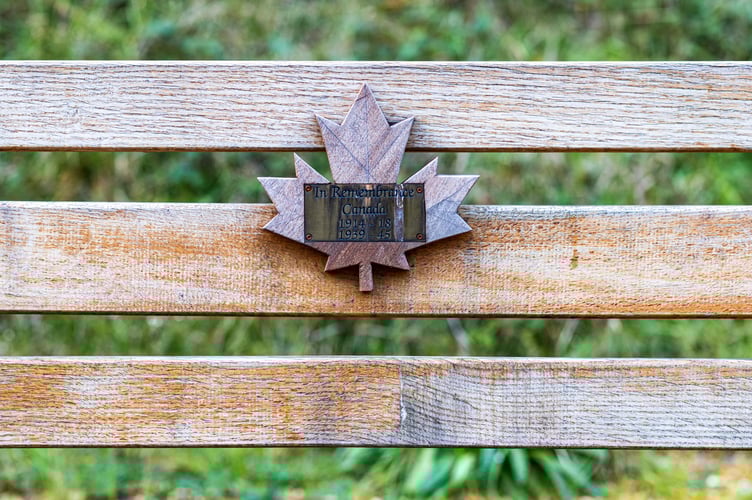A plaque on a bench - commemorating Canadian 418 soldiers who died in both World Wars. October 22 2023. Photo released October 27 2023. See SWNS story SWLNmaples. Stunning photos show autumnal red maple trees dotted along a motorway - commemorating Canadian 418 soldiers who gave their lives during war. Many motorists are unaware they are passing through a treasured war memorial on the A3 in Hampshire.A total of 418 of these maples, Canadaâs national tree, were placed along the A3 near Liphook to mark the lives of 418 Canadian servicemen who died in both World Wars. The servicemen trained locally and died at Bramshott during both wars.There was a Canadian training base in the area, as well as a large hospital caring for sick and wounded soldiers.