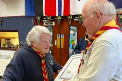 Mon Spiers receives her Chief Scout’s 50 Year Service Award from Malcolm Vincent.