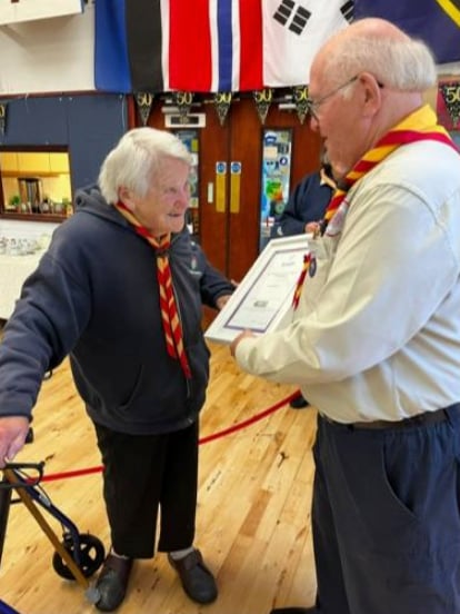 Mon Spiers receives her Chief Scout’s 50 Year Service Award from Malcolm Vincent.