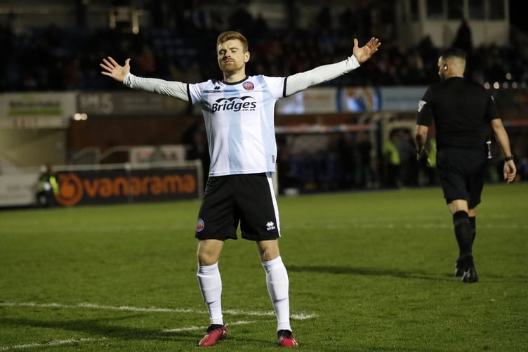 Jack Barham salutes the Shots fans after scoring the decisive penalty