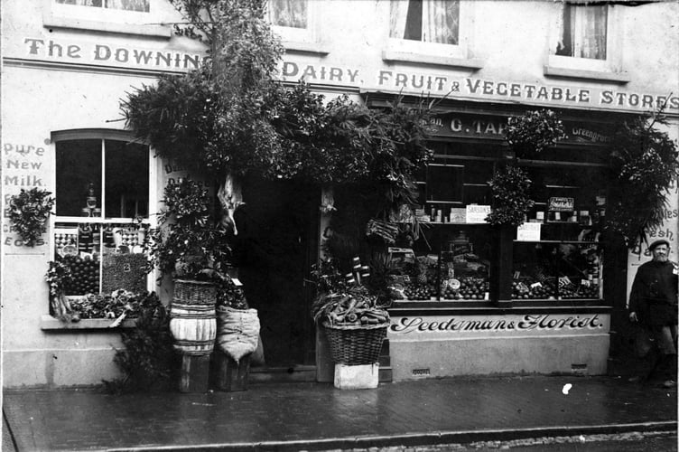 Christmas trees and wreaths on sale outside The Downing Street Dairy, G Taphouse, in Downing Street, Farnham