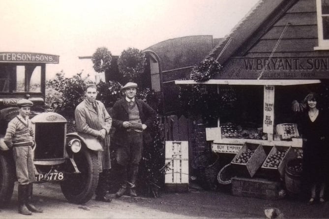 Christmas wreaths for sale outside W Bryant & Sons at Golden Ball Farm Shop, Petersfield, circa 1930