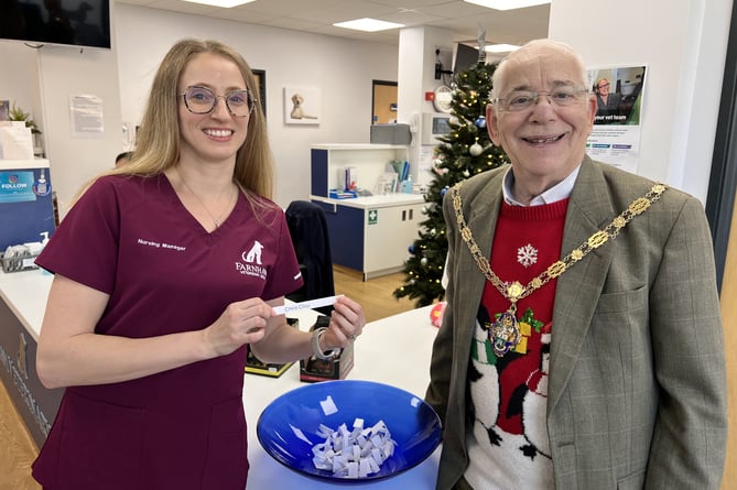 The mayor of Farnham and Alison Ruse from Farnham Veterinary Hospital announce the winner of the Twelve Days of Christmas competition