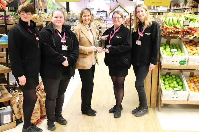 Sarah Squire (chairman, Squire’s Garden Centres), centre, presenting the ‘Food Hall of the Year’ Award 2023 to the Squire’s Frensham Food Hall team