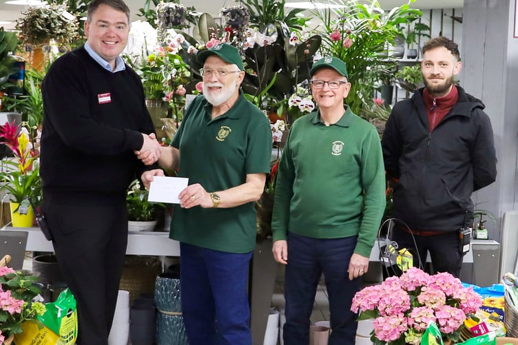 Squire’s Badshot Lea centre manager Brian Phillips (left) presents the Love Where You Live award to John Martin from Badshot Lea Community Garden