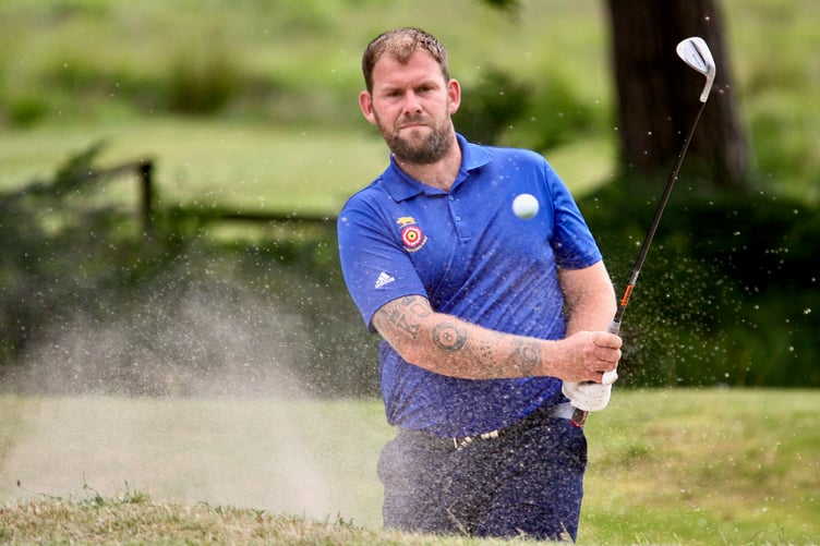 Blackmoor Golf Club's Sam Parsons splashes out of the bunker by the 12th green at Brokenhurst Manor in his South East League match against Sussex's Sam Russell (Photo: Andrew Griffin/AMG Pictures)