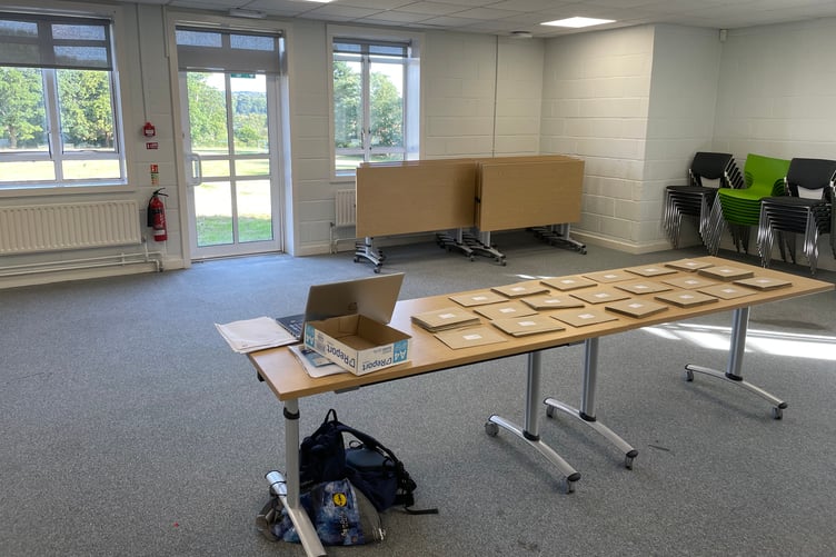 Table of A- Level results awaiting students at Farnham College