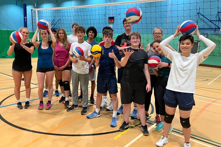 A group of teenagers and adults are enjoying volleyball sessions in Haslemere