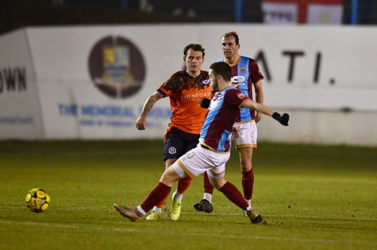 Farnham Town's Darryl Sanders competes for possession
