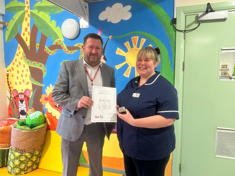 Hannah Thomson, senior sister at Hampshire Hospitals, is presented with her Queen's Nurse certificate and pin badge by Justin Wright, child health lead for integrated community services at Hampshire Hospitals, February 2025.