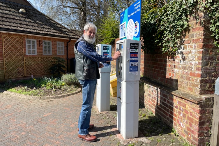 Geoff Peach, 74, of Elstead uses the ticket machine in Central Car Park in Farnham.