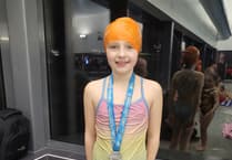 Tears of joy as inspirational Bordon pupil swims 5k for charity