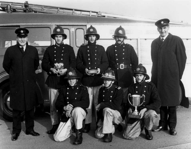 The Alton Fire Brigade drill competition crew show off their trophies. Don Welton is standing on the far right. Circa late 1950s/early 1960s.