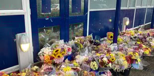 Flowers laid outside school as two students die on same day