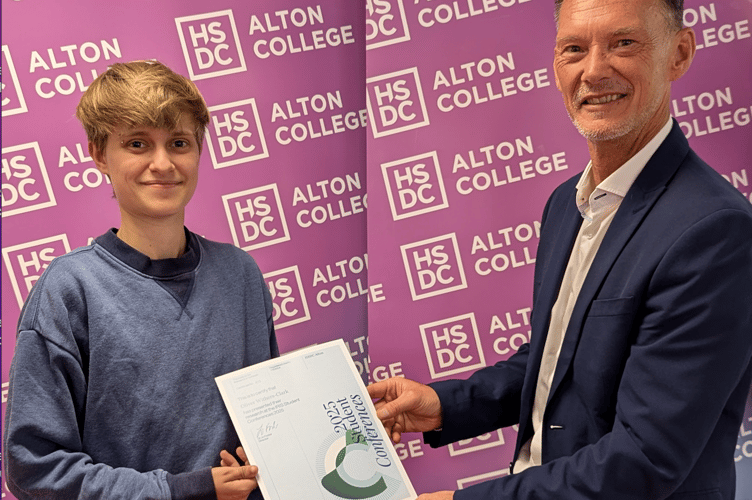Oliver Withers-Clark receives a certificate from the Institute for Research in Schools Conference presented by Alton College's assistant principal for curriculum Ashley Grute, Alton College, August 14th 2025.